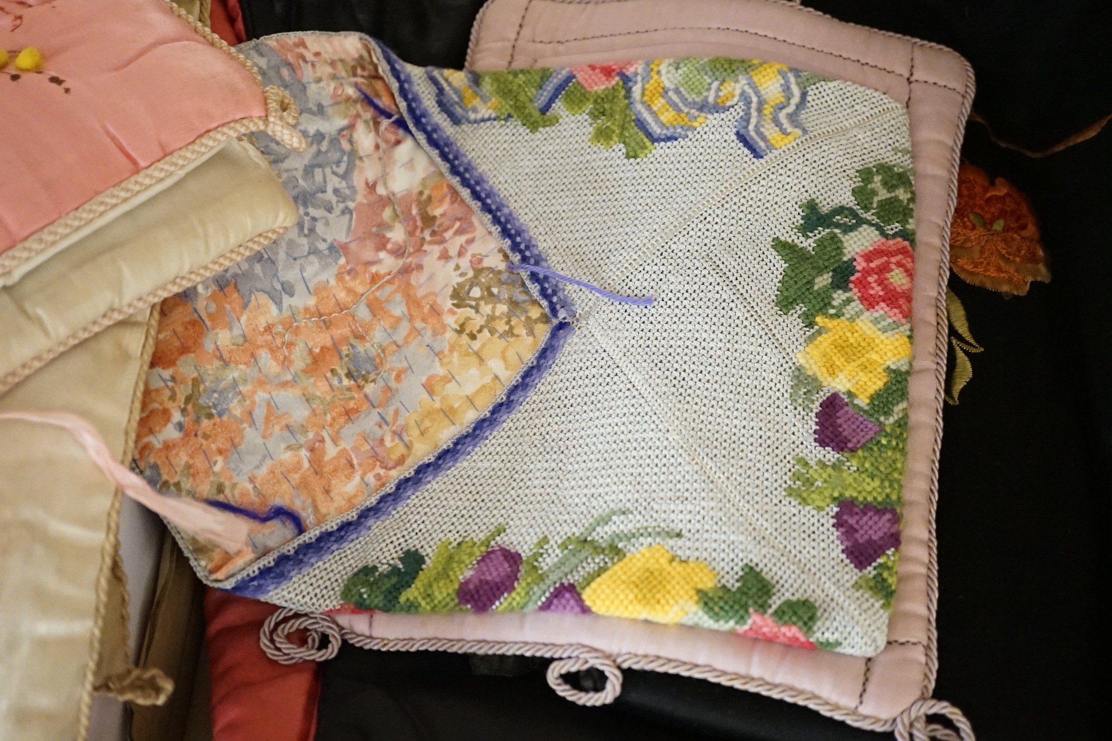 A large collection of mixed European textiles including ribbon worked pyjama cases, Indian painted textiles, a sample book of braidings etc
